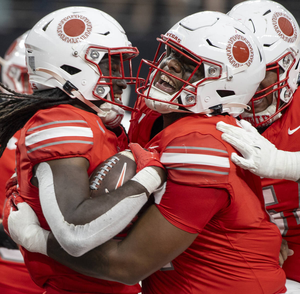 After scoring a touchdown, UNLV running back Devin Green, left, is lifted up by offensive linem ...