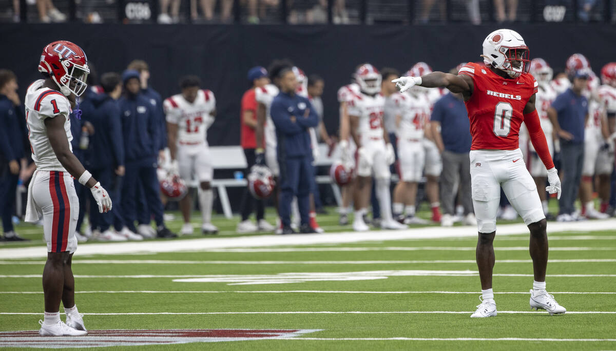 UNLV Rebels defensive back Tony Grimes (0) points and laughs as Utah Tech wide receiver DaJon H ...