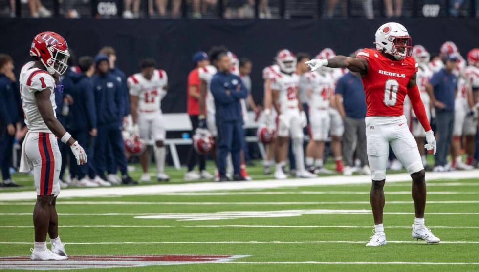 UNLV Rebels defensive back Tony Grimes (0) points and laughs as Utah Tech wide receiver DaJon H ...