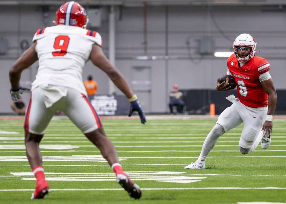 UNLV quarterback Hajj-Malik Williams (6) prepares to juke Utah Tech linebacker Amari Pouncy (9) ...