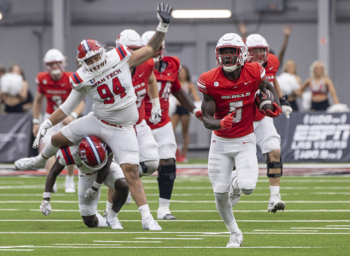 UNLV running back Greg Burrell (5) runs with the ball during the college football game against ...