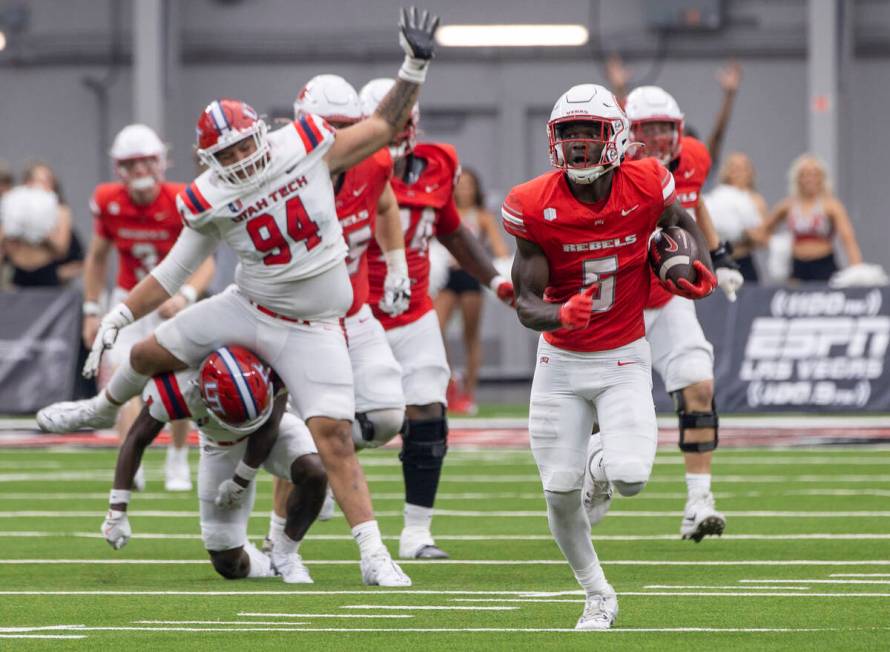 UNLV running back Greg Burrell (5) runs with the ball during the college football game against ...