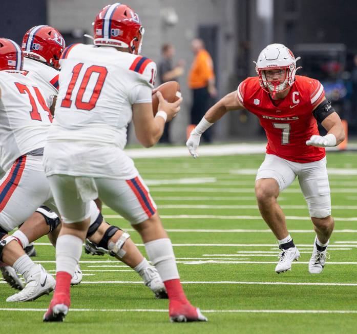 UNLV linebacker Jackson Woodard (7) runs toward Utah Tech quarterback Deacon Hill (10) during t ...