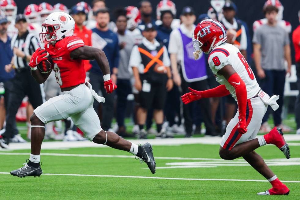 UNLV running back Jai'Den Thomas (9) runs the ball as Utah Tech Trailblazers defensive back Jag ...