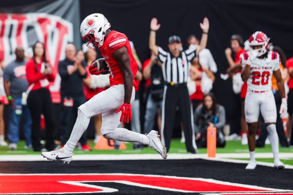 UNLV running back Greg Burrell leaps into the end zone for a touchdown during an NCAA football ...