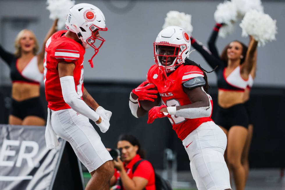 UNLV running back Devin Green (22) celebrates a touchdown with teammate Timothy Conerly (8) dur ...