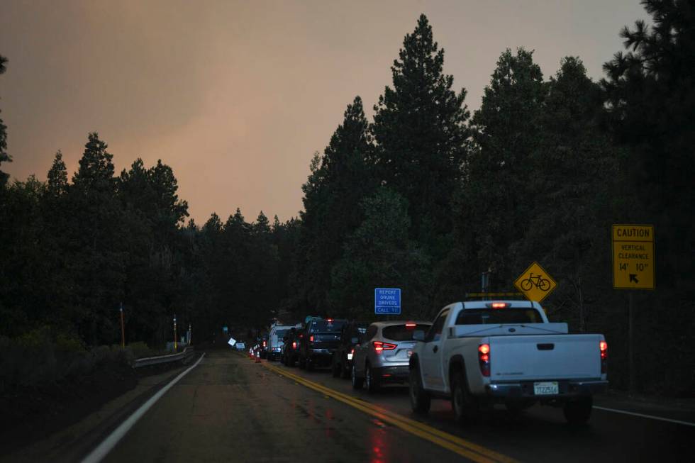 Motorists line up in the outskirts of town as smoke from the Line Fire fills the air Saturday, ...