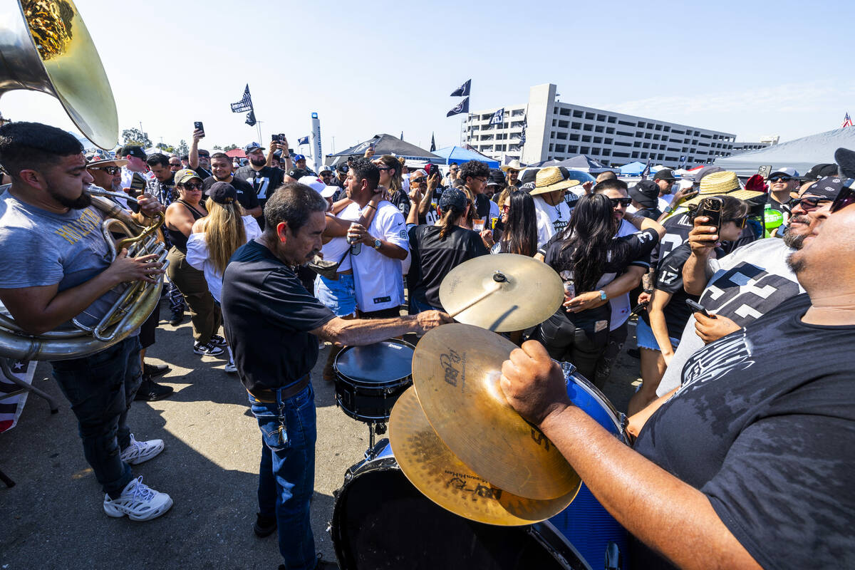 A band plays as fans dance in the tailgate area before the Raiders face the Los Angeles Charger ...