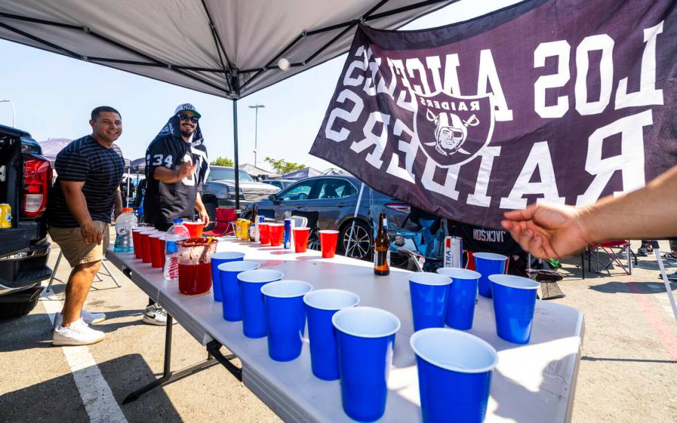 Fans play beer pong in the tailgate area before the Raiders face the Los Angeles Chargers in an ...