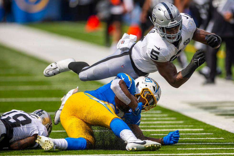 Raiders linebacker Divine Deablo (5) soars past Los Angeles Chargers running back J.K. Dobbins ...