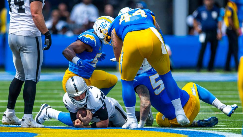 Raiders quarterback Gardner Minshew (15) is sacked by Los Angeles Chargers linebacker Khalil Ma ...