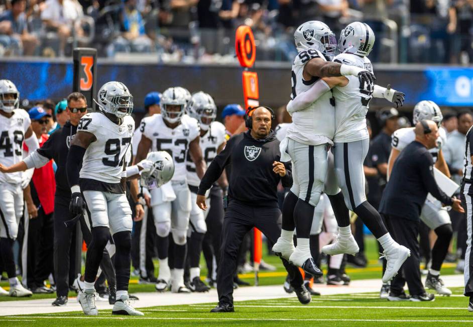 Raiders defensive end Maxx Crosby (98) celebrates a sack with defensive tackle Nesta Jade Silve ...