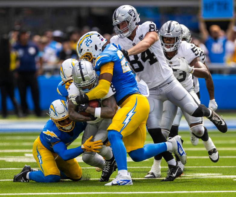 Raiders running back Ameer Abdullah (8) is stopped on a run b y Los Angeles Chargers linebacker ...