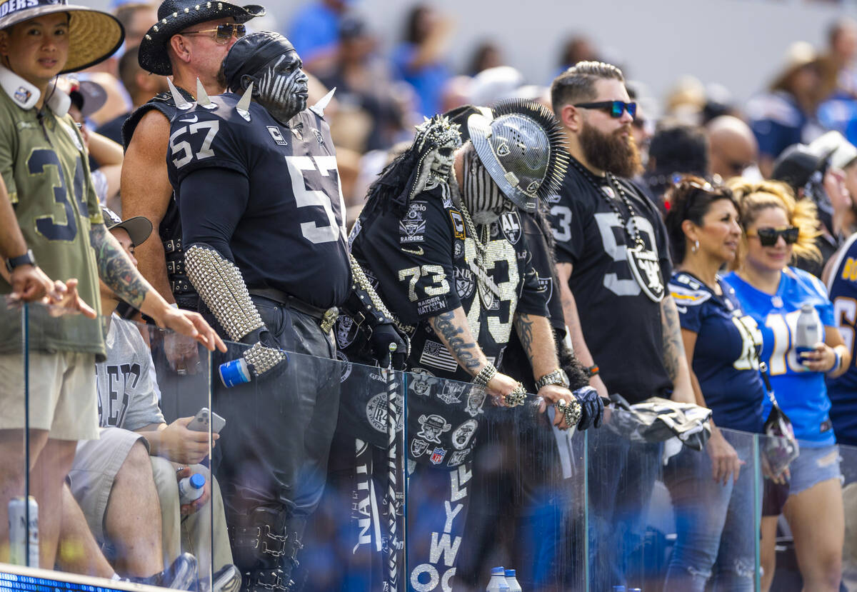 Raiders fans stand dejected as the Los Angeles Chargers score a late touchdown during the secon ...