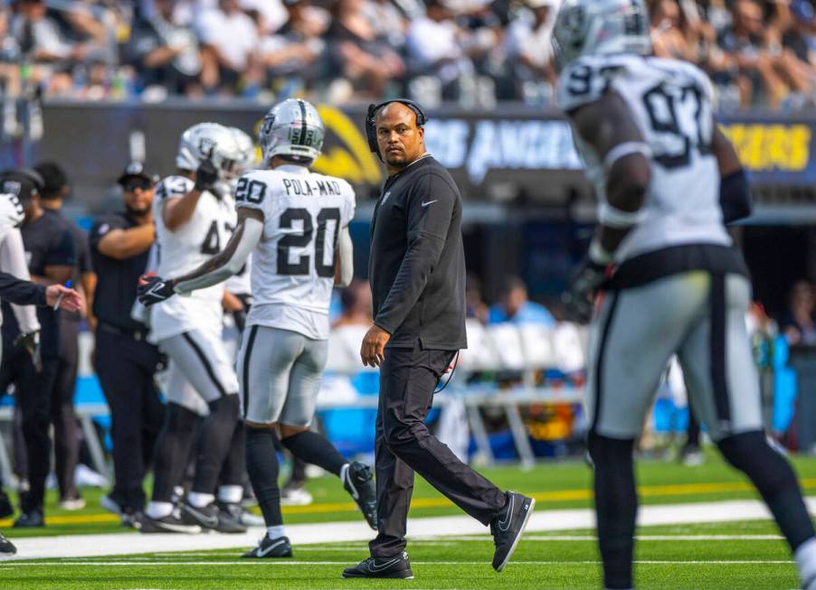 Raiders head coach Antonio Pierce looks back on his way to the sidelines during the second half ...