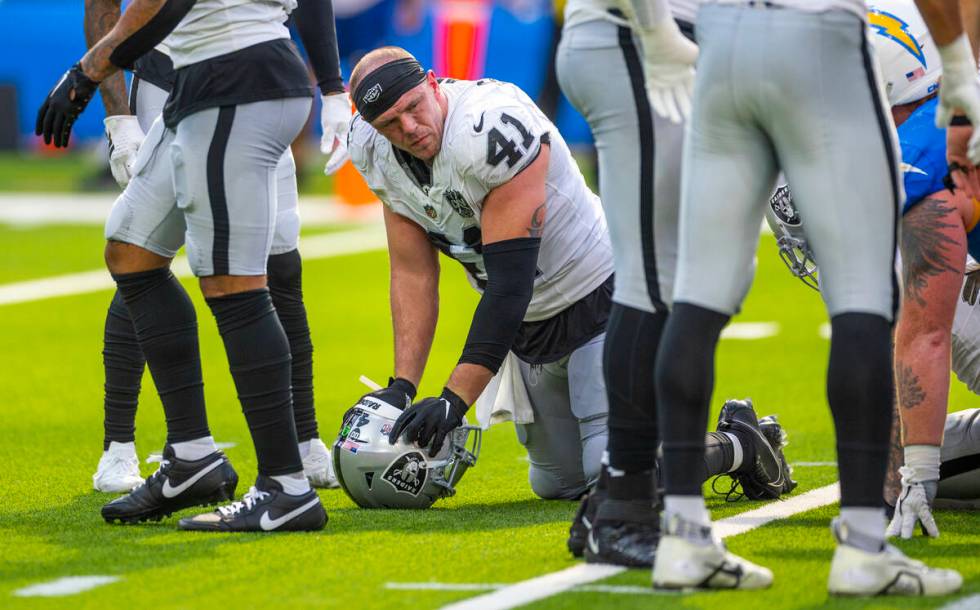 Raiders linebacker Robert Spillane (41) is spent on the field as the game nears and end against ...