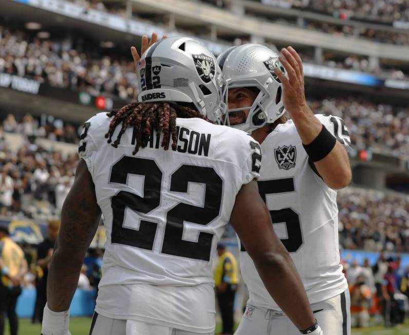 Raiders quarterback Gardner Minshew (15) congratulates Raiders running back Alexander Mattison ...