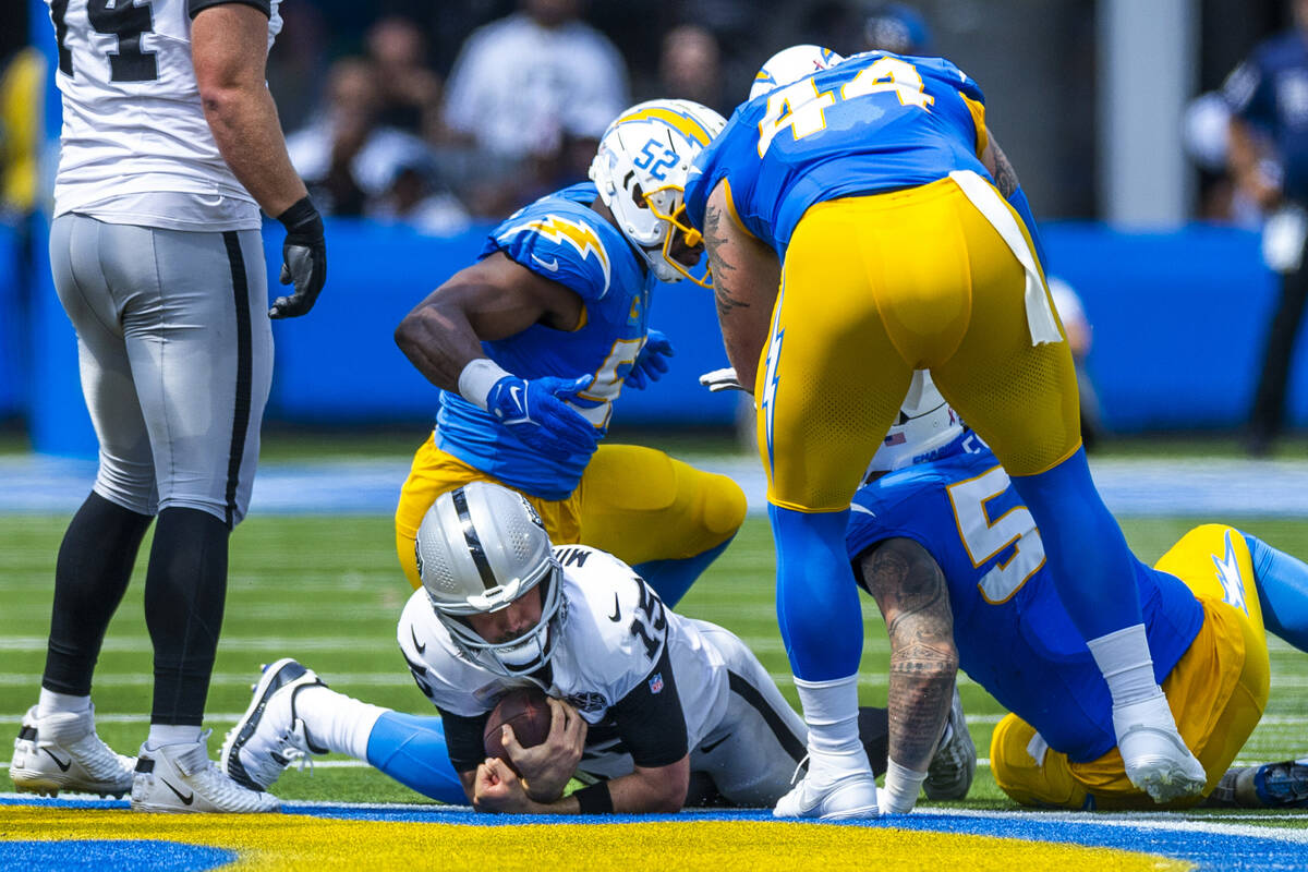 Raiders quarterback Gardner Minshew (15) is sacked by Los Angeles Chargers linebacker Khalil Ma ...