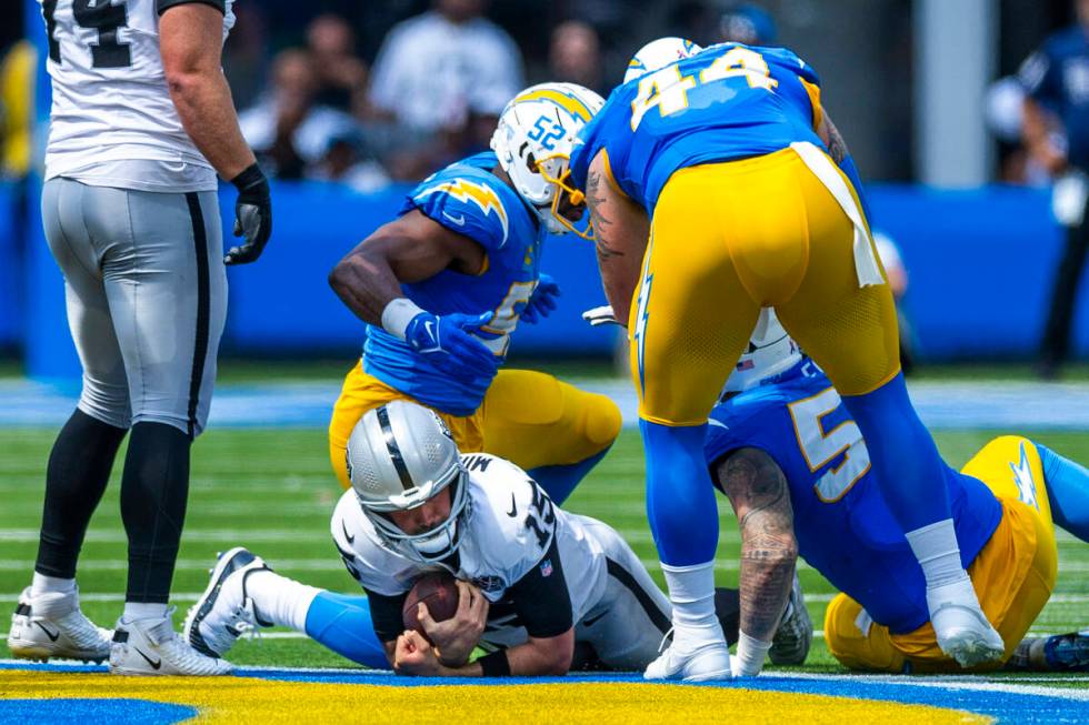 Raiders quarterback Gardner Minshew (15) is sacked by Los Angeles Chargers linebacker Khalil Ma ...