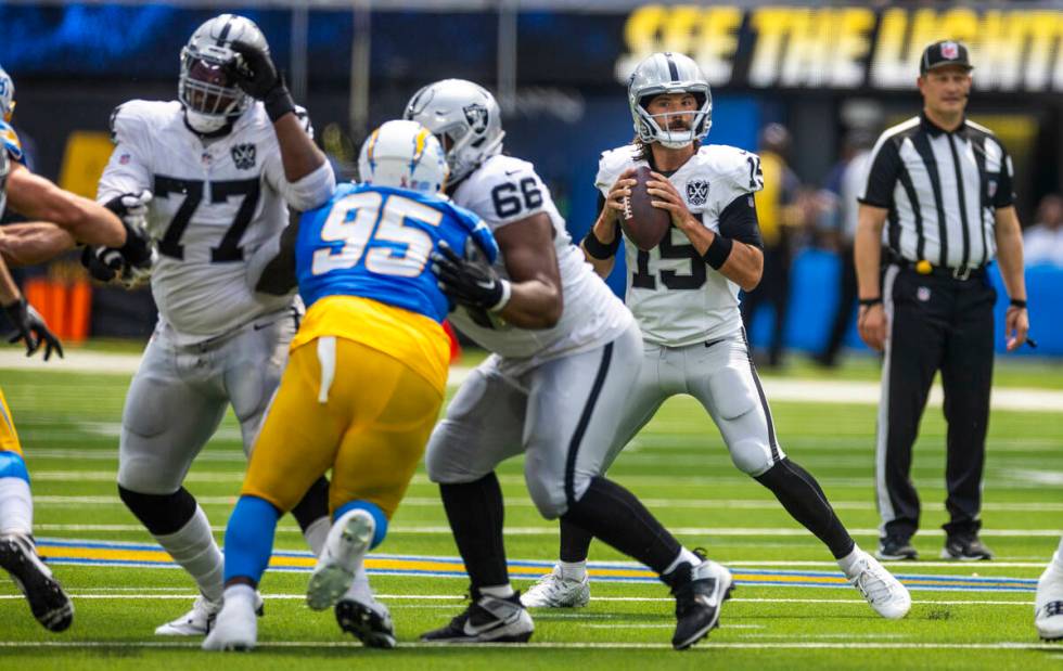 Raiders quarterback Gardner Minshew (15) looks to pass against the Los Angeles Chargers during ...