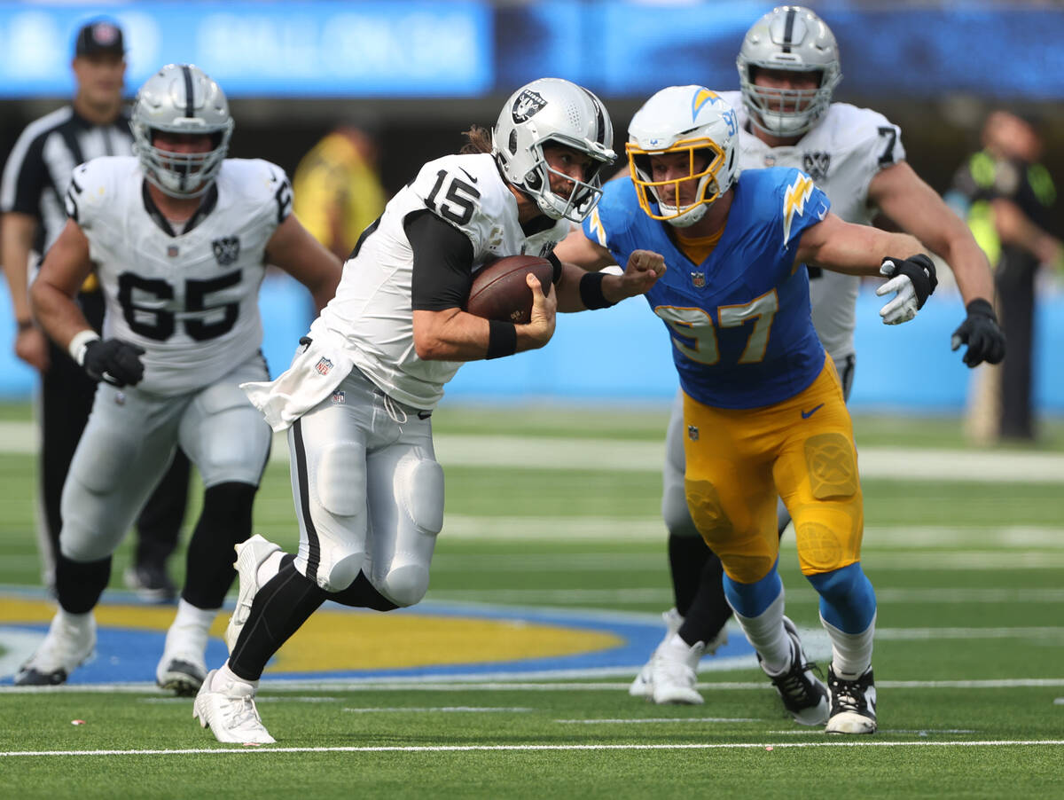 Los Angeles Chargers linebacker Joey Bosa (97) pursues Raiders quarterback Gardner Minshew (15) ...