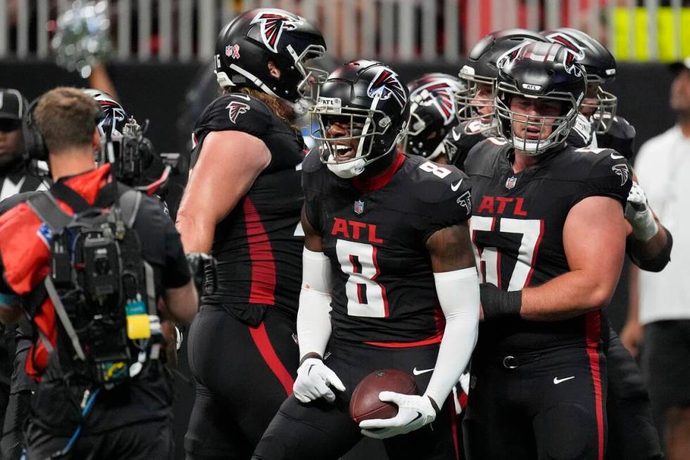 Atlanta Falcons tight end Kyle Pitts (8) reacts after a touchdown catch during the first half o ...