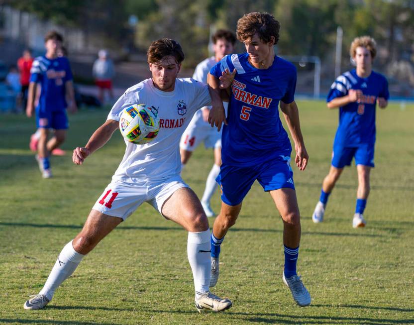 Coronado striker Gavin Flickinger (11) battles for control of the ball with Bishop Gorman midfi ...