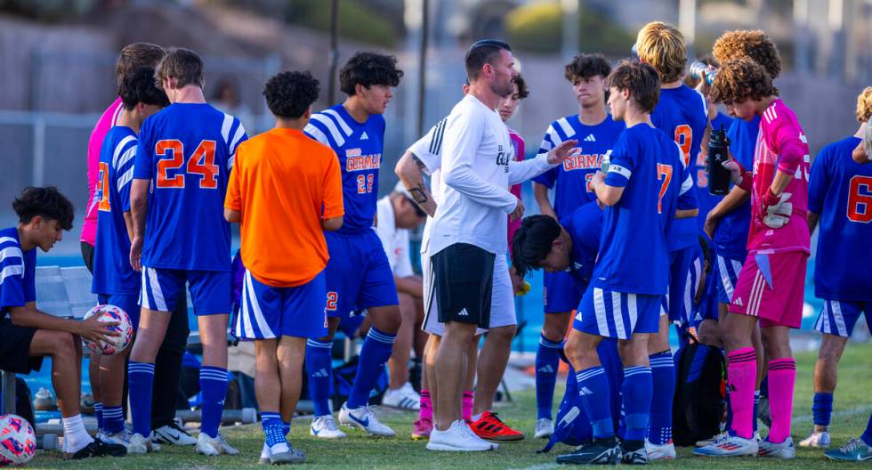 Bishop Gorman head coach Victor "Boomer" Arbelaez counsels his players during a timeo ...