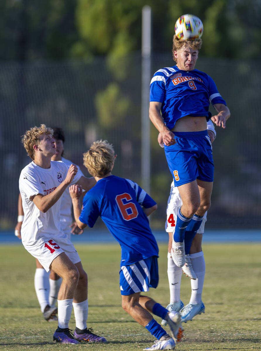 Bishop Gorman forward Chase Stewart (9) heads the ball past Coronado defender Ben Aronow (15) a ...