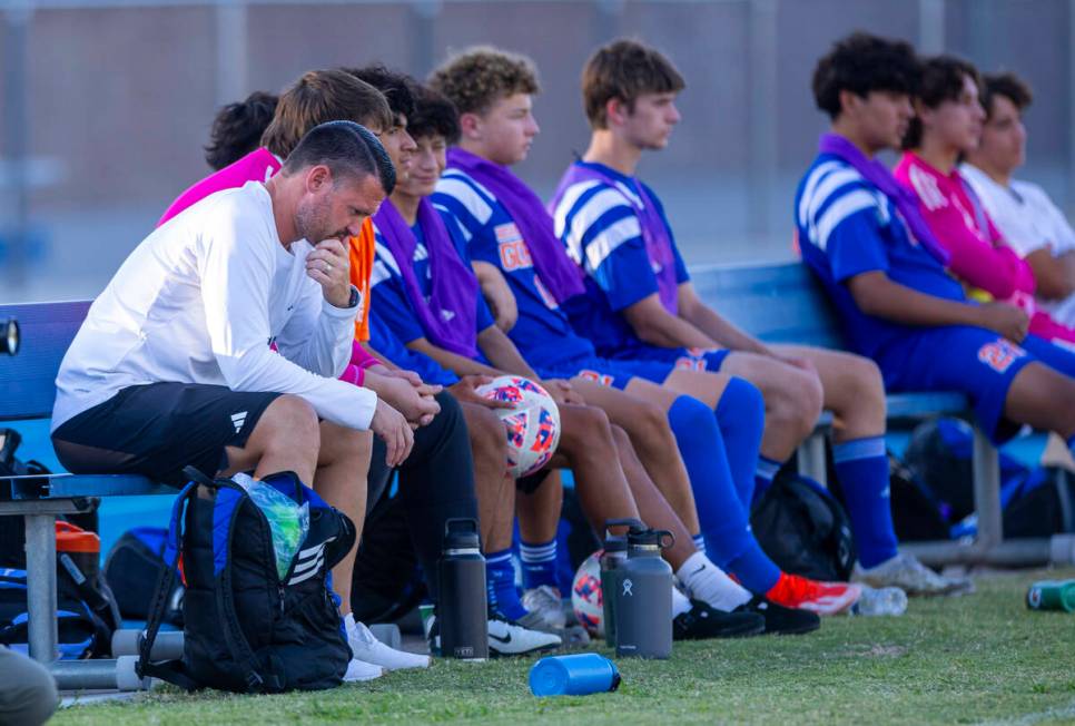 Bishop Gorman head coach Victor "Boomer" Arbelaez sits dejected on the bench as Coron ...