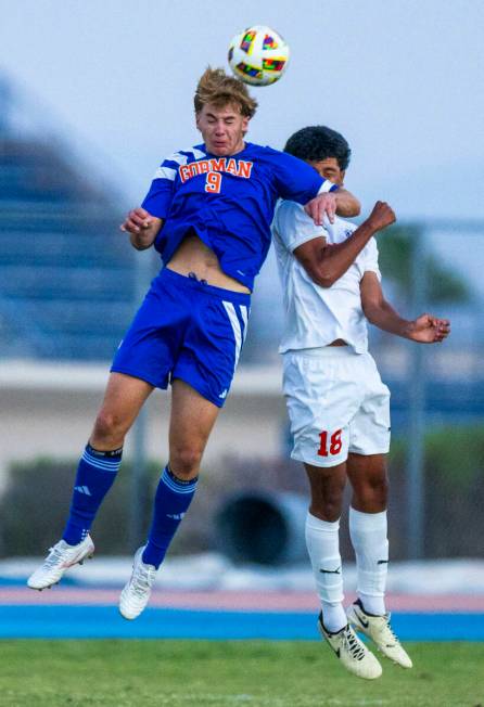 Bishop Gorman forward Chase Stewart (9) heads the ball away from Coronado midfielder Josh Pined ...