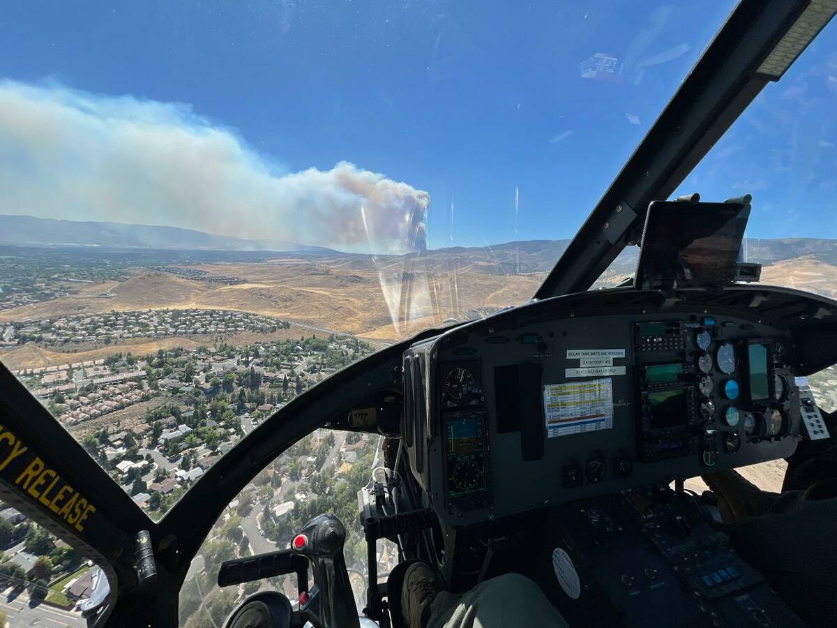 A smoke plume from the Davis fire is seen from a firefighting helicopter Sunday, Sept. 8, 2024. ...