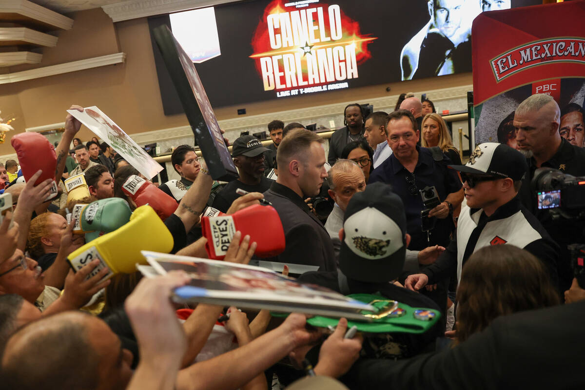 Fans crowd Canelo Alvarez as he leaves the stage after arriving to MGM Grand for his super midd ...