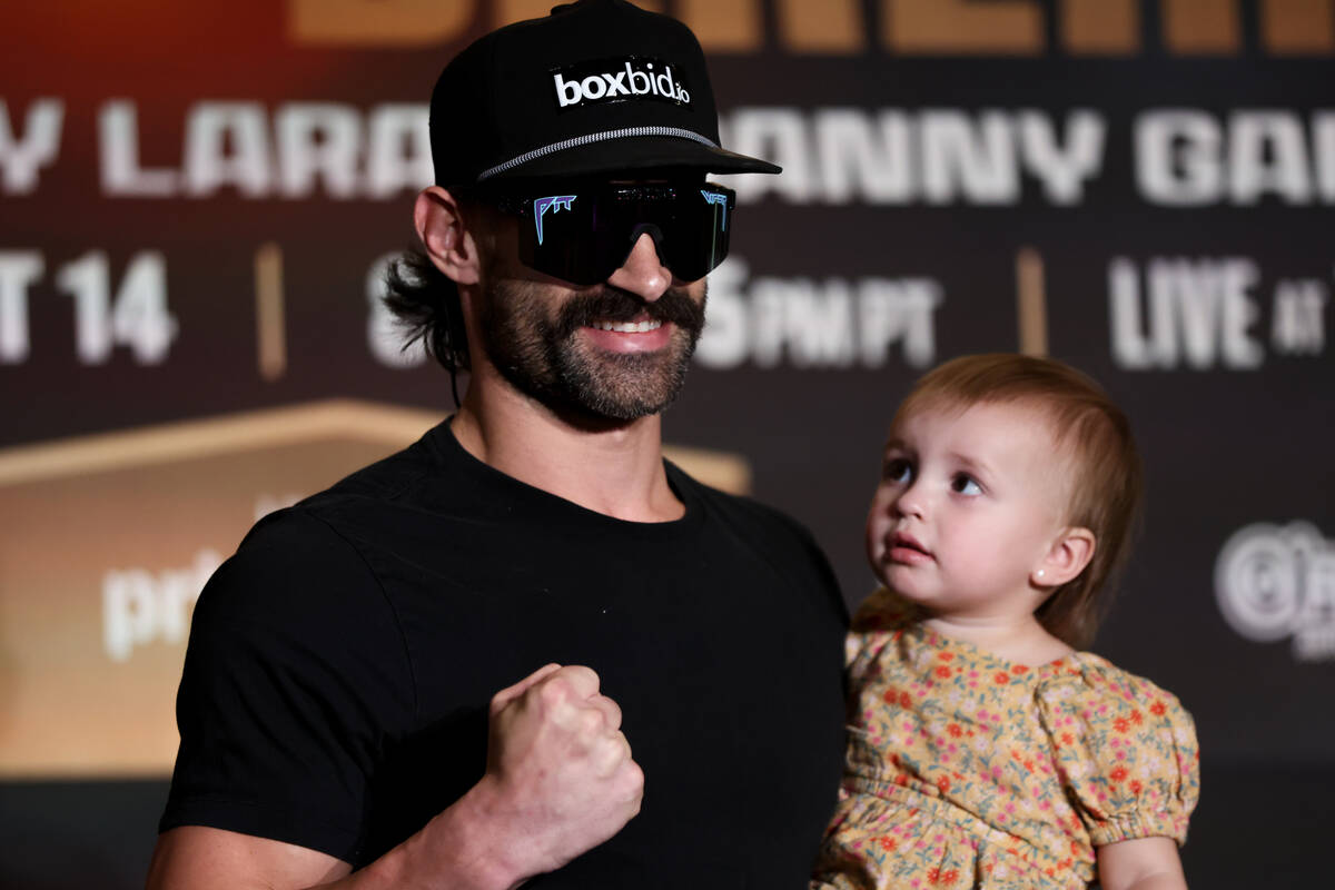 Trevor McCumby poses on stage with his daughter ahead of his WBA interim super middleweight tit ...