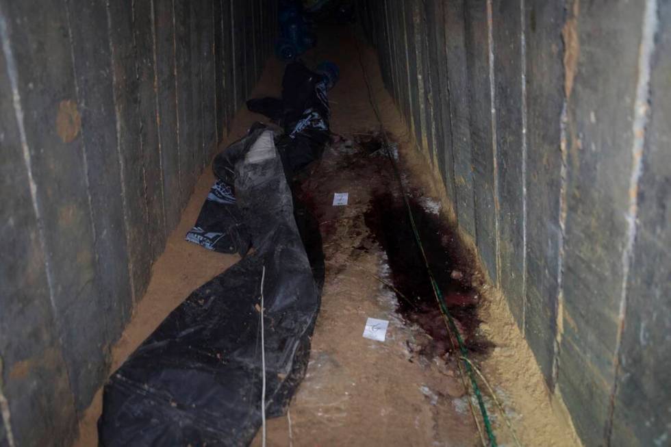 This undated photo released by the Israel Defense Forces shows the Gaza tunnel where it says si ...