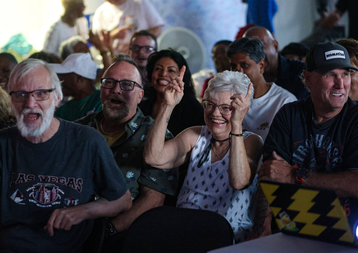 Monica Bradford, center, reacts during a watch party of the presidential debate between Kamala ...