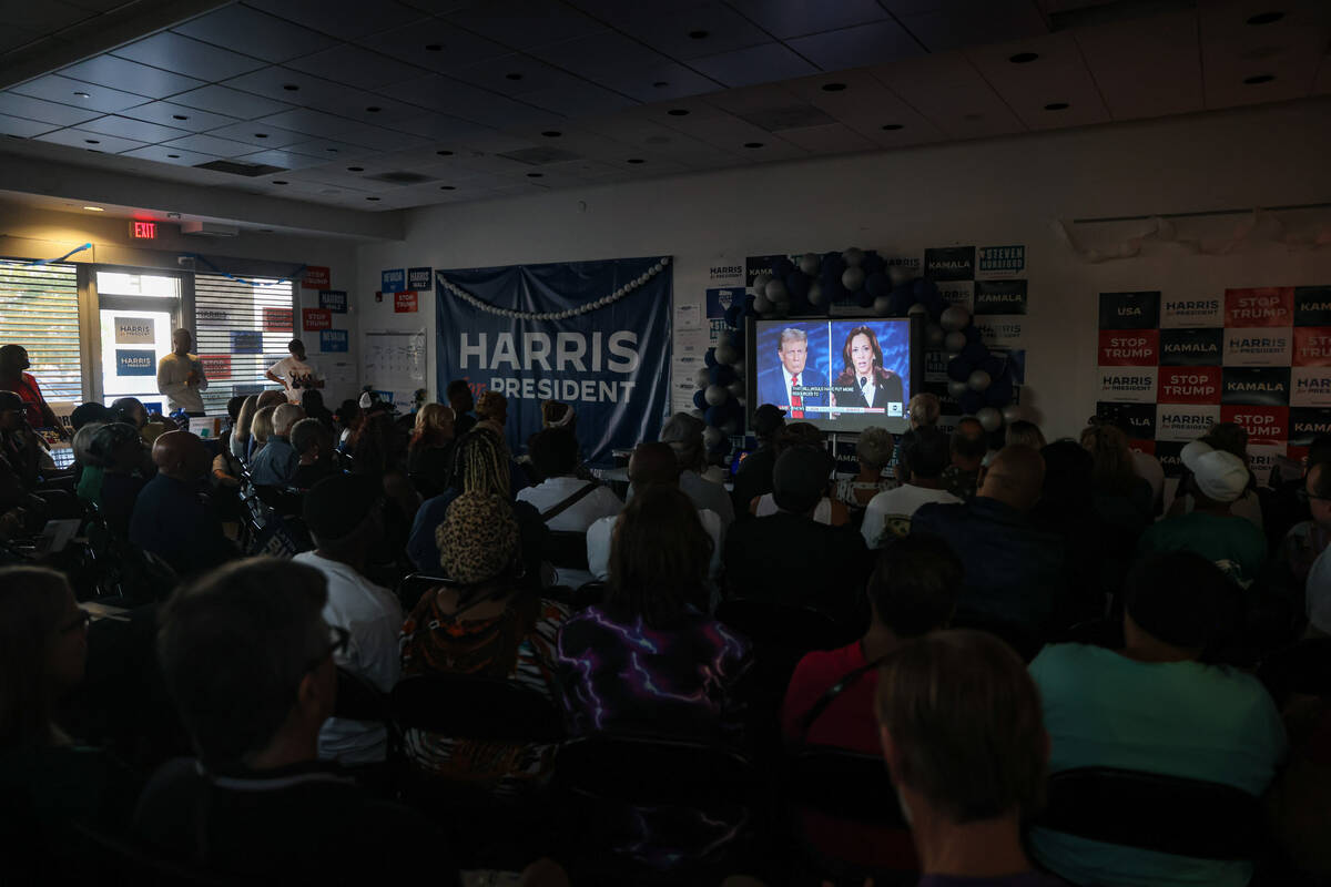 Attendees watch the presidential debate between Kamala Harris and Donald Trump at the Harris-Wa ...