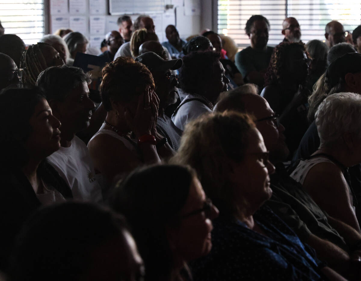 Attendees watch the presidential debate between Kamala Harris and Donald Trump at the Harris-Wa ...