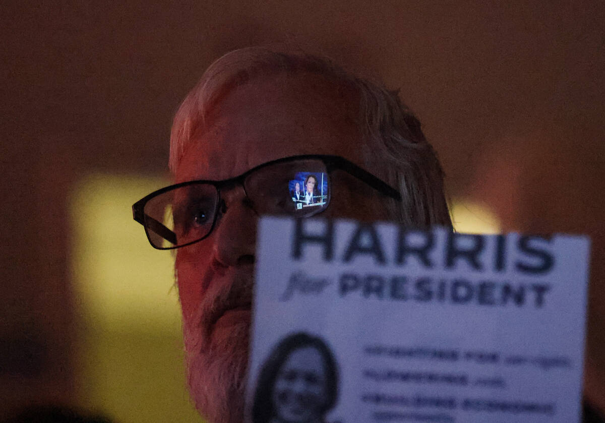 Kevin Cheshire, of Utah, watches the presidential debate between Kamala Harris and Donald Trump ...