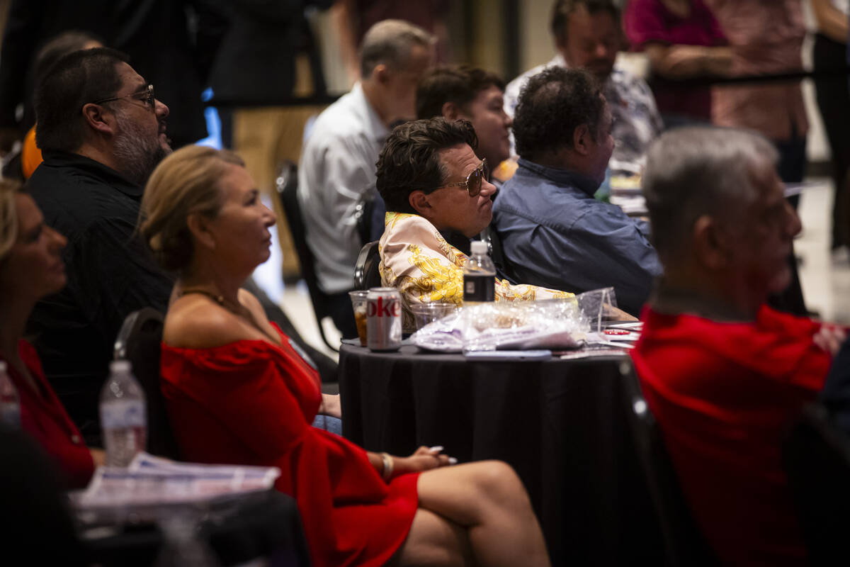 Supporters of Republican presidential nominee former President Donald Trump react during a tele ...