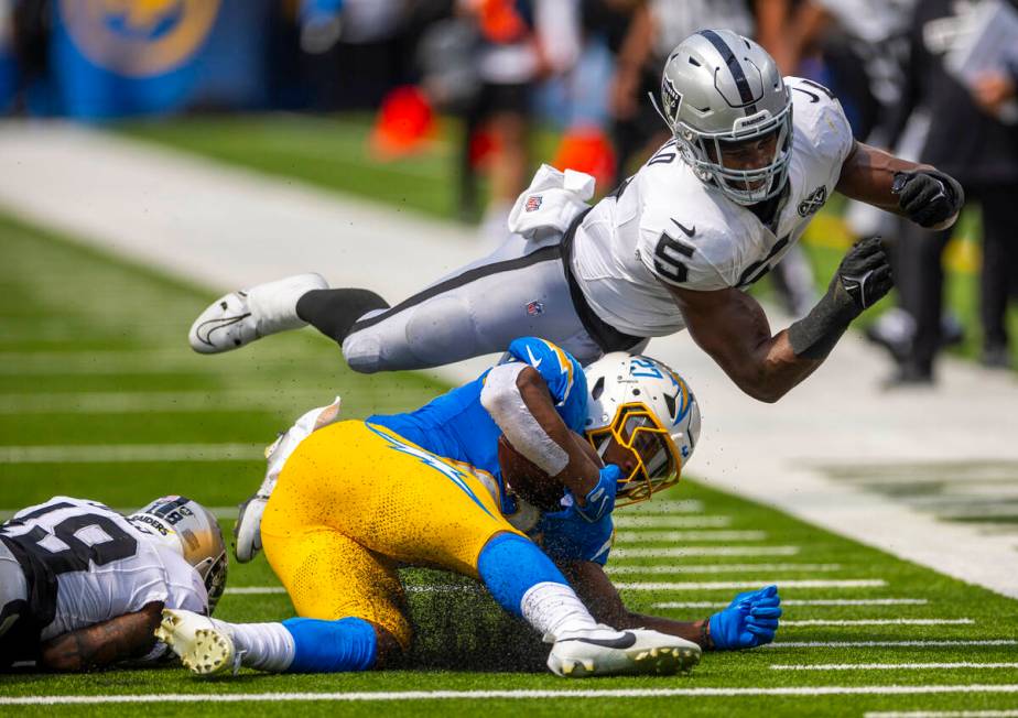 Raiders linebacker Divine Deablo (5) soars past Los Angeles Chargers running back J.K. Dobbins ...