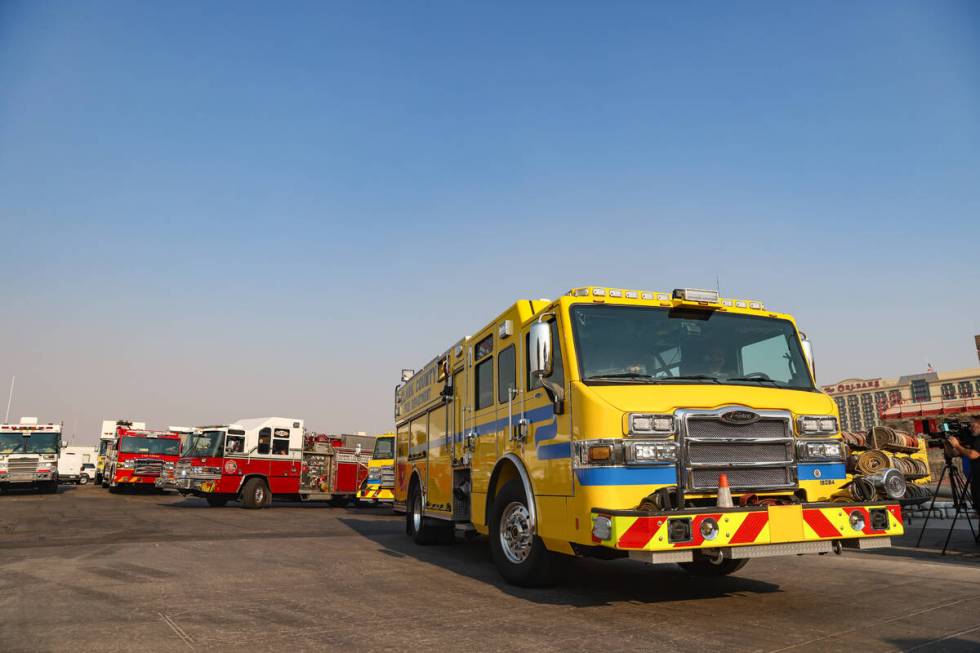 Firefighters depart to the Davis Fire from the Clark County Fire Department training center in ...