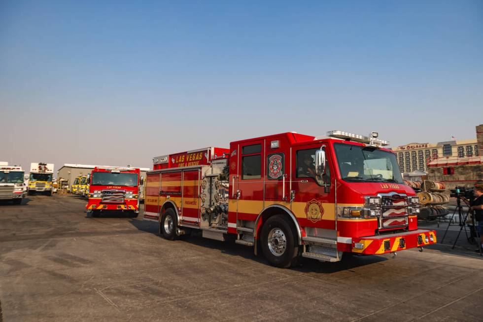 Firefighters depart to the Davis Fire from the Clark County Fire Department training center in ...