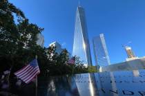 Flags are placed by the names of those killed during the Sept. 11, 2001, attacks at the reflec ...