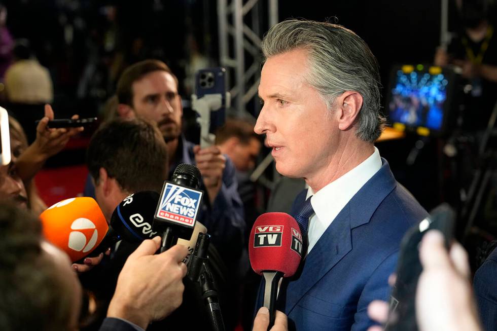 California Gov. Gavin Newsom speaks to reporters in the spin room after a presidential debate b ...