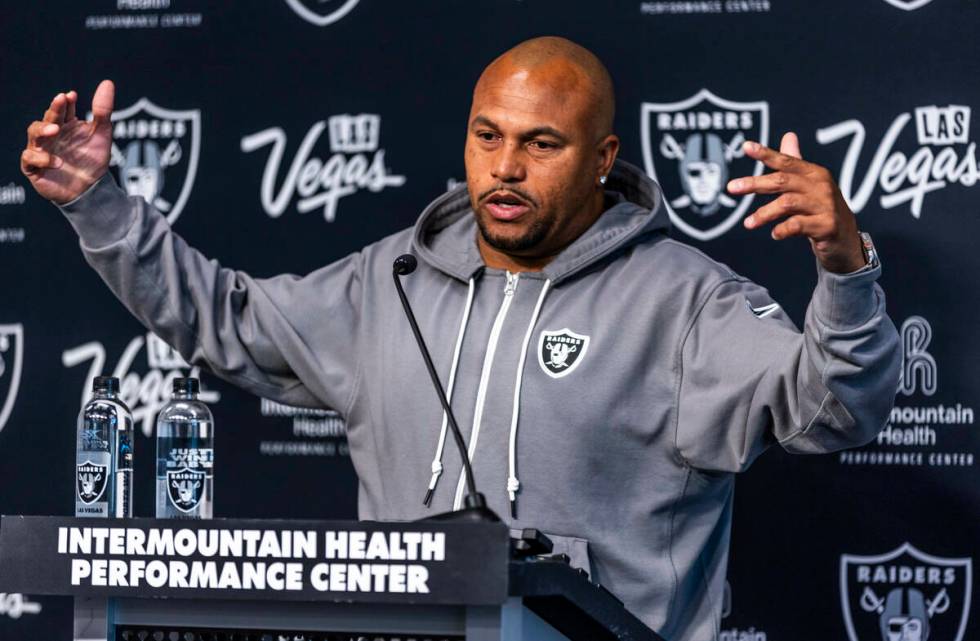 Raiders head coach Antonio Pierce answers a question during a media interview before practice a ...