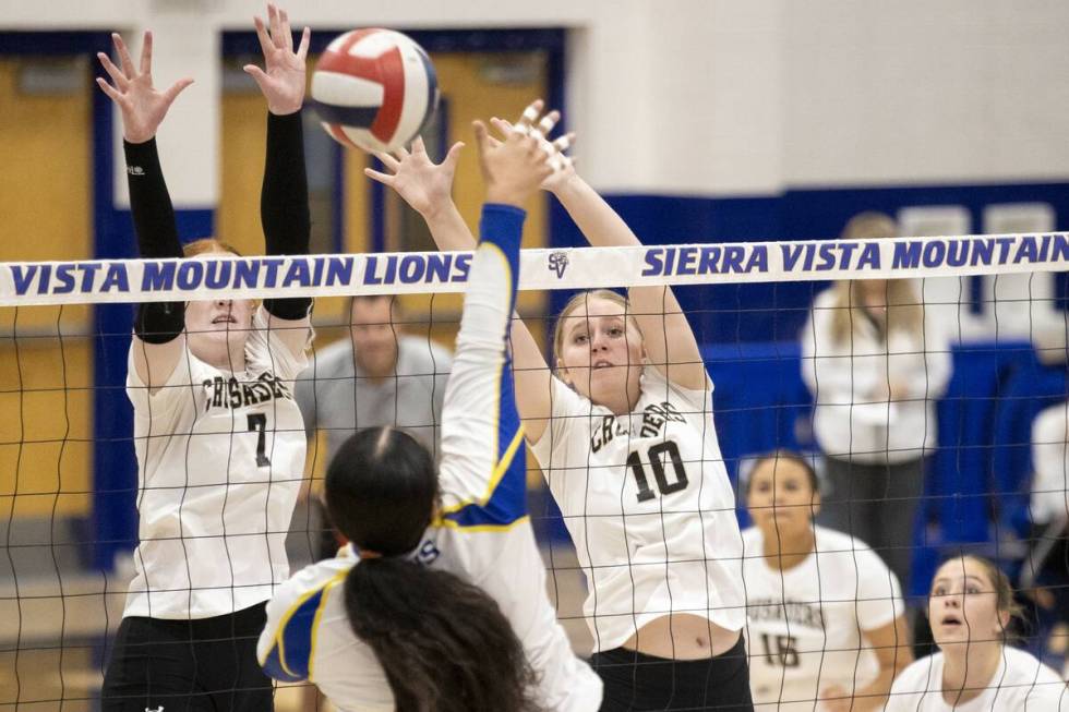 Faith Lutheran junior Parker LaFontaine (7) and sophomore Abby Keyes (10) attempt to block a sp ...