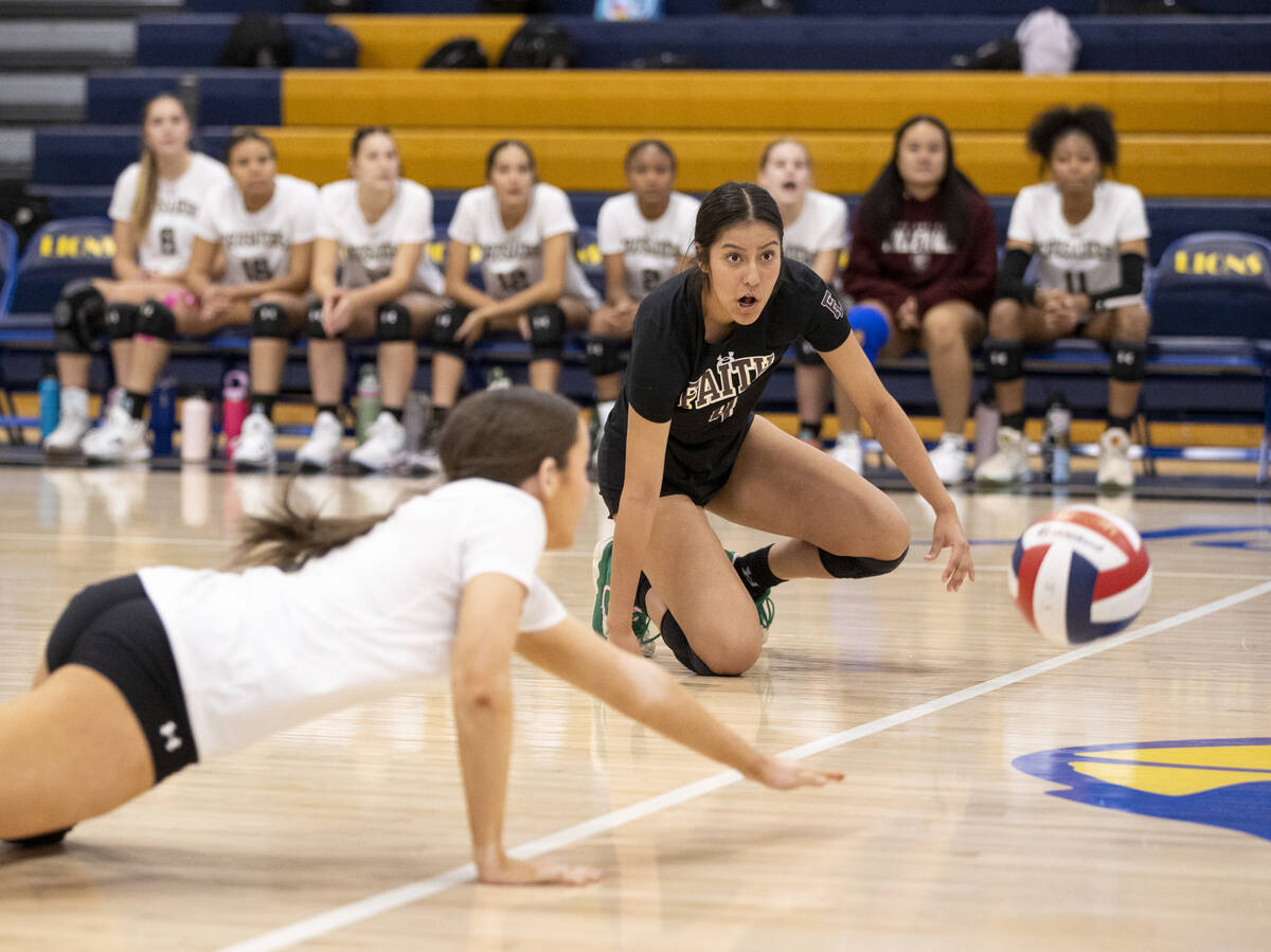 Faith Lutheran freshman Olivia Kiel (3) and junior Leah Hernandez (4) dive for the ball during ...