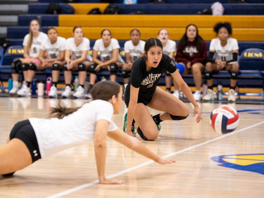 Faith Lutheran freshman Olivia Kiel (3) and junior Leah Hernandez (4) dive for the ball during ...