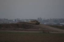 An Israeli tank overlooks the Gaza Strip, as seen from southern Israel, Wednesday, Sept. 11, 20 ...